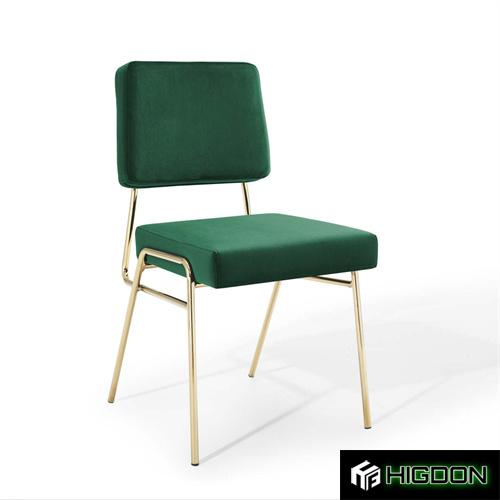 Luxurious armless green velvet dining chair with golden metal feet