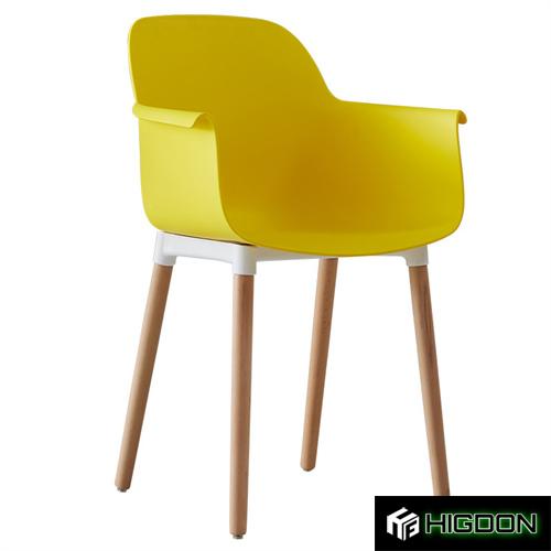 Stylish yellow plastic armchair with wood feet
